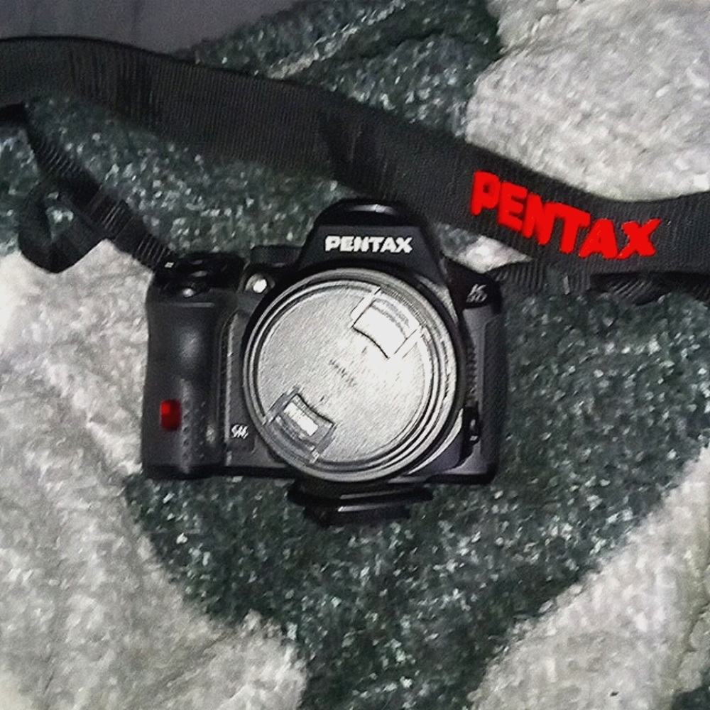 Pentax K-30 series with 18-55 (lens) and an additional Nikon lens 75-150